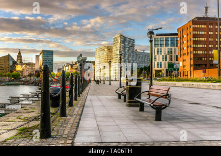 Cobbled Pavement lined with beches along Liverppol waterfront at sunset Stock Photo