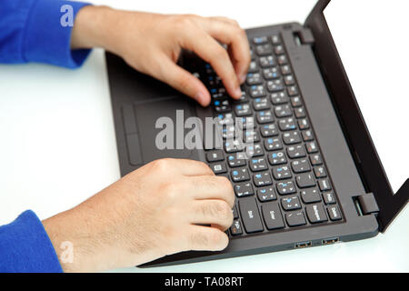 hands of a young man typing on a laptop. the view from the top Stock Photo