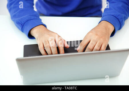 hands of a young man typing on a laptop. the view from the top Stock Photo