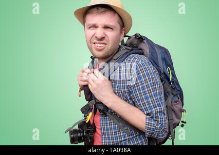 Tired young tourist in summer hat is tired and lost. Stock Photo