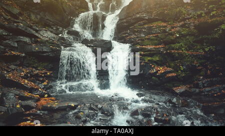 Pure Wild Highland Waterfall Creek Stony Ground. Rapid Transparent Mountain Creek Flow Rocky Ground Bottom. Mountainous Slope Multicolored Foliage Clean Ecology Concept