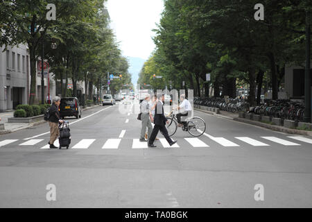 SAPPORO - September 5 : Commuters hurry on May 5, 2014 in Sapporo , Hokkaido. People crossing street Stock Photo