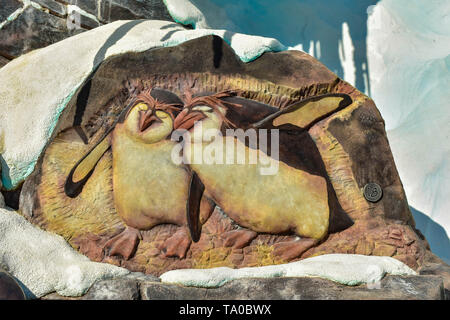 Orlando, Florida . February 26,  2019. Beautiful penguins carved in the rock at Seaworld Theme Park. Stock Photo