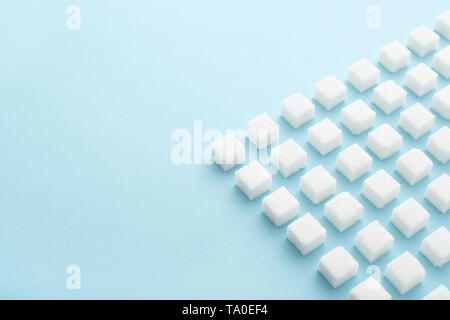 Sugar cubes geometry pattern on pastel blue background with copy space. Abstract, creative, minimal style. Stock Photo
