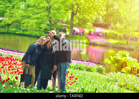 Lisse, Belgium - April 25, 2019: A couple of middle age family taking a selfie photo in Keukenhof Gardens Stock Photo