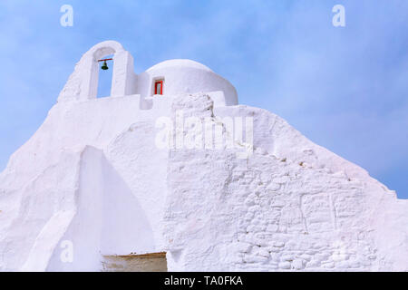 Mykonos, Greece landmark, white Paraportiani Church on famous greek island, close-up on blue sky background Stock Photo