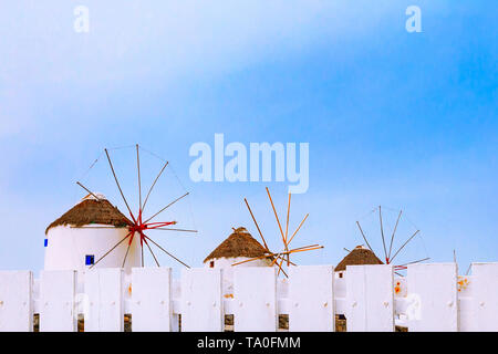 Mykonos, Greece, copy space background with greek iconic windmills and white fence in famous island in Cyclades Stock Photo