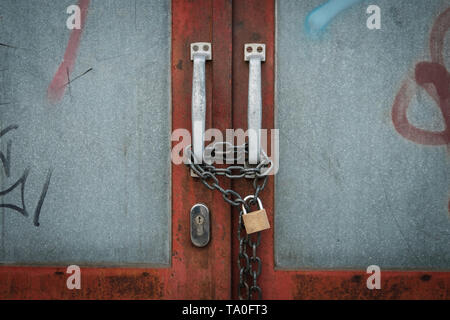 closed door locked with chain and padlock - vintage gate Stock Photo