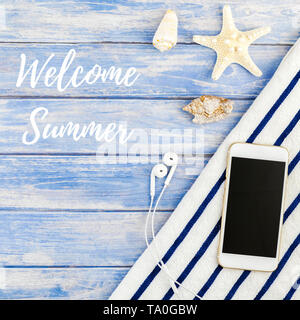 Square Creative flat lay concept of summer travel vacations. Top view of beach towel smartphone seashells starfish on pastel blue wooden planks backgr Stock Photo