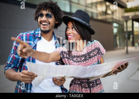 Happy couple on vacation sightseeing city with map Stock Photo