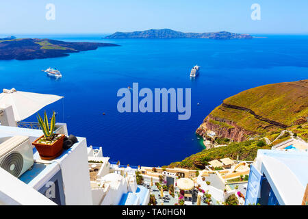 Santorini, Greece iconic view of white houses, caldera, volcano island and sea panorama with cruise ship Stock Photo