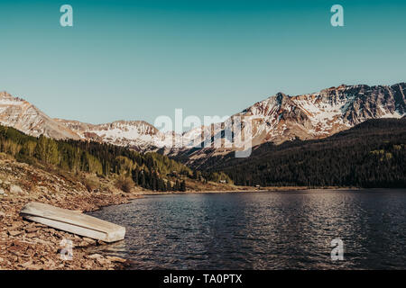 A boat resting ashore the alpine waters of Trout Lake in the Rocky Mountains near Telluride, Colorado, USA Stock Photo