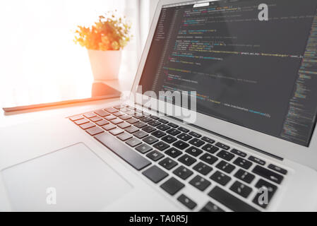 Programming code on laptop screen. Code language, website developer workplace at office. Stock Photo