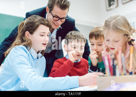 Teacher and students working together in a group or team session Stock Photo