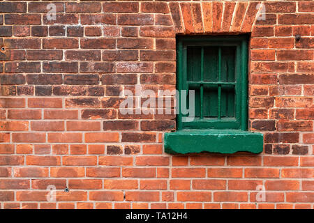 Small window in brick wall Stock Photo