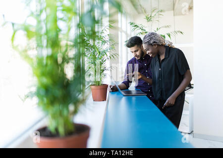 Business partners working on laptop at modern office Stock Photo
