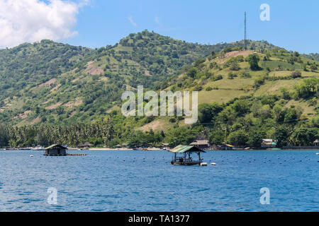 BALI, INDONESIA - December 01, 2013: Approaching the coast of Lombok, Balis neighbouring Island, by Boat on a beautiful day blue skies. Stock Photo