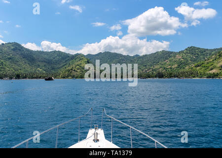 BALI, INDONESIA - December 01, 2013: Approaching the coast of Lombok, Balis neighbouring Island, by Boat on a beautiful day blue skies. Stock Photo