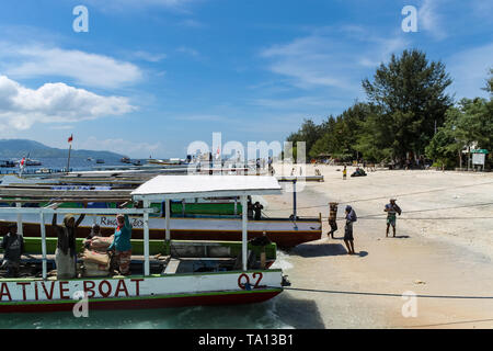 GILI AIR, INDONESIA - December 01, 2013: Sandy Beach with Boats on Gili Trawangan. The biggest of the three popular Islands near Lombok, Indoniesia. Stock Photo