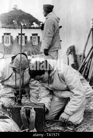 A radio operator of a Luftwaffe rifle battalion tries to contact the leadership. They are located in an unknown village at the Don Bend, presumably in Kursk Oblast, during the winter defensive battles in the spring of 1943. Photo of the Propaganda Company (PK): war correspondent Siedel. Stock Photo