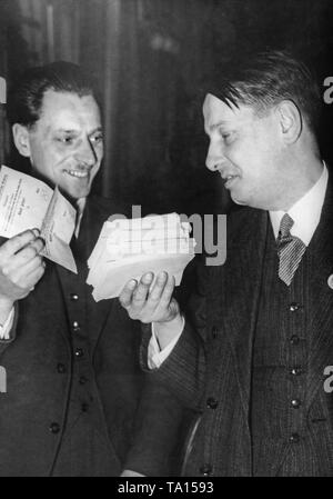 Two campaign workers hold the counted ballots in their hands. On the right the No votes and on the left the Yes votes. At the referendum was voted on the annexation of Austria to the German Reich. Stock Photo