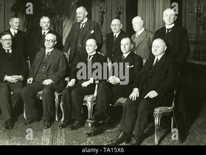 The new national government under Chancellor Heinrich Bruening (cabinet Bruening I) after the first council. Sitting from left to right: Interior Minister Joseph Wirth (Centre Party), Economy Minister and Vice Chancellor Hermann Robert Dietrich (DDP), Heinrich Bruening (Centre Party), Foreign Minister Julius Curtius (DVP), Postal Minister Georg Schaetzel (BVP). Standing: Minister of Occupied Territories Gottfried Reinhold Treviranus (KVP), Minister of Agriculture Martin Schiele (DNVP), Justice Minister Johannes Viktor Bredt (Economic Affairs), Finance Minister Paul Moldenhauer (DVP), Stock Photo