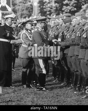 Photo of Field Marshal General, Hermann Goering, while he is awarding the Spanish Golden Cross and the Spanish Golden Cross with brillants to pilot officers of the Condor Legion, who have returned from Spain, during a victory parade in the Hamburg Moorweide at the Dammtor. The officers are already wearing the Spanish Military Medal (left) and the Medal for the Campaign (Medalla de la Campana) (on the right). Stock Photo