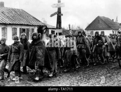 Soviet prisoners of war are walking down a street in the direction of the POW camp in the Ukrainian town of Shytomyr (Zhitomir). Photo of the Propaganda Company (PK): War correspondent Carl. Stock Photo