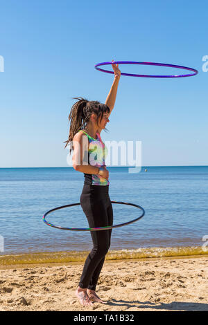 Southbourne, Bournemouth, Dorset, UK. 21st May 2019. UK weather: lovely warm sunny morning as Lottie Lucid performs her hula hooping routine on the beach at Southbourne, enjoying the warm sunny weather. Credit: Carolyn Jenkins/Alamy Live News