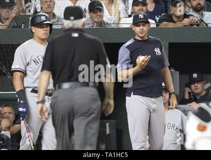 Baltimore, Maryland, USA. 20th May, 2019. New York Yankees manager Aaron Boone (17), right, is questioning umpire Larry Vanover (27) who wants a review of second baseman Gleyber Torres' (25) eighth inning home run against the Baltimore Orioles at Oriole Park at Camden Yards in Baltimore, MD on Monday, May 20, 2019. Looking on at left is third baseman Gio Urshela (29). The Yankees won the game 10 - 7 Credit: Ron Sachs/CNP/ZUMA Wire/Alamy Live News Stock Photo