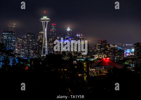 Seattle skyline on a cloudy night with the Space Needle in foreground from Kerry Park in Seattle, Washington, USA