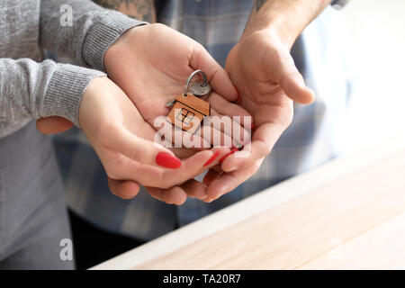 Couple holding key from house. Property insurance concept Stock Photo
