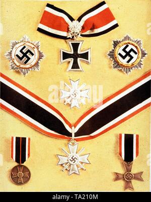 German medals from the period 1939-1945. Above the Knight's Cross of the Iron Cross with Oak Leaves, Swords and Diamonds, left the Silver at right the Gold German Cross. Bottom row, the War Merit Cross and the Knight's Cross of the War Merit Cross. At the bottom left and right unknown medals. Stock Photo