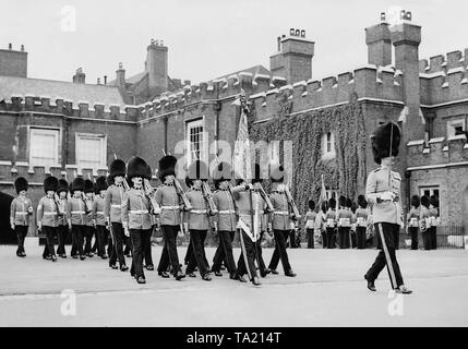Due to the illness of King George VI, the Changing of the Royal Guard takes place in the court of St. James's Palace in London, instead of the forecourt of Buckingham Palace. Stock Photo