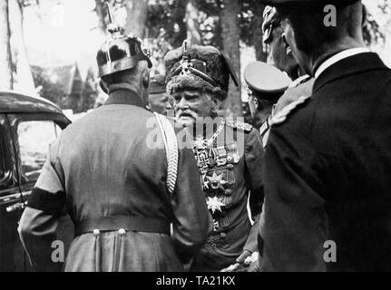 The field marshal of the Imperial Army August von Mackensen in his hussar uniform talking to an officer in the uniform of the old army, who wears a black ribbon on the upper arm. The occasion is a funeral. Stock Photo