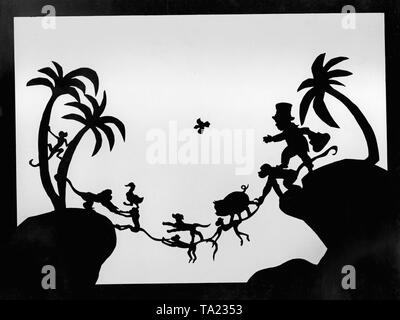 This photo shows a scene from the silhouette film 'Dr. Dolittle and His Animals' - subtitle: 'The Bridge of Apes' by Charlotte Reiniger. The silhouette film, also known as silhouette animation, is a technique of animated film in which silhouettes are put together on a lighted glass plate in front of a white or black background to form a film. The result is the silhouette film, inspired by shadow theater and the pictorial techniques of silhouette cutting.