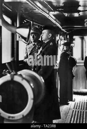 Albert Speer (left) and Karl Doenitz (right of him) on the bridge of a ship of the German Kriegsmarine during a test ride. Stock Photo