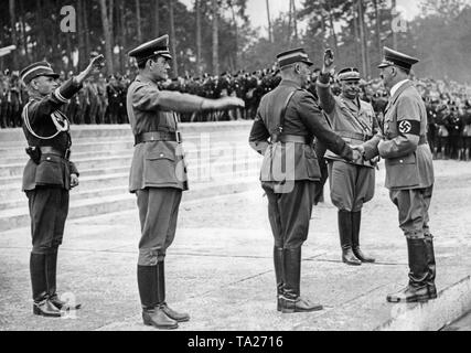 Adolf Hitler (right) at the groundbreaking ceremony of the Deutsches Stadion on the Nazi Party Rally Grounds in Nuremberg. He is received by Albert Speer, Viktor Lutze, Hanns Kerrl (2nd from right to left). Stock Photo