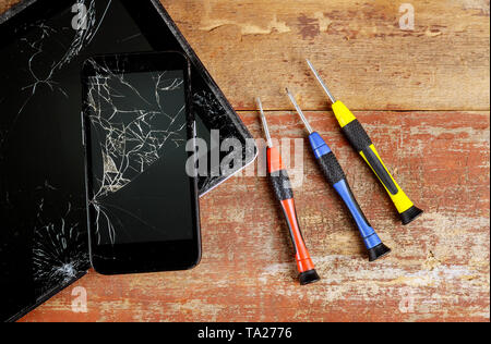 Repairs the tablet and smart phone top view of working in screwdriver Stock Photo