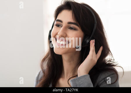 Customer service. Friendly Surrort Phone Operator At Workplace Stock Photo