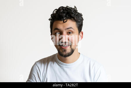 Portrait of a young man with braces smiling. A happy young man with braces on a white background. Stock Photo
