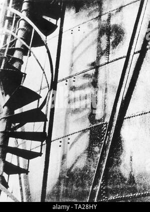 The flash of the atomic bomb explosion has left the shadow of a spiral staircase in an iron wall. Stock Photo