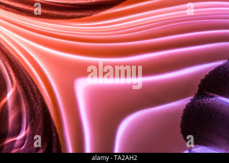 Futuristic abstract background with beautiful glowing neon colorful lines with gradient from red, orange to pink, violet colors. Stock Photo