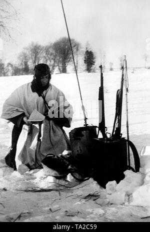 A German radio operator reports on the events on the front. He is situated southeast of Lake Ilmen at the northern sector of the Eastern Front. Photo of the Propaganda Company (PK): war correspondent Jacobi. Stock Photo