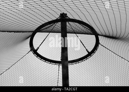 Abstract image of metal circle frame and pole with suspending wires and nets. Stock Photo