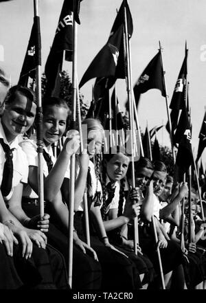 After their flag march, BDM girls are watching the sports events at the Reichsportfest (sports festival of the Reich) of the BDM at the Stadium Neukoelln in Berlin. Stock Photo