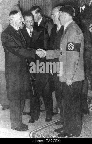 After the final discussions of the Sudeten problem, British Prime Minister Arthur Neville Chamberlain (left) and Adolf Hitler say goodbye to each other on the steps of the Rheinhotel Dreesen in Bad Godesberg (Ruengsdorf). To the right beside Chamberlain, the British Ambassador to Berlin Sir Nevile Henderson, to the left beside Hitler, Paul-Otto Schmidt (Chief Interpreter at the Foreign Office). Stock Photo
