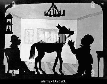 This photo shows a scene from the silhouette film 'Dr. Dolittle and His Animals' - subtitle: 'Das kranke Pferd' by Charlotte Reiniger. The silhouette film, also known as silhouette animation, is a technique of animated film in which silhouettes are put together on a lighted glass plate in front of a white or black background to form a film. The result is the silhouette film, inspired by shadow theater and the pictorial techniques of silhouette cutting.