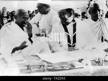The leader of the Indian Nationalists Mahatma Gandhi and the President of the 51st Indian National Congress in Haripura, Subhas Chandra Bose. Gandhi laughs at a joke of Subhas Chandra Bose. Stock Photo