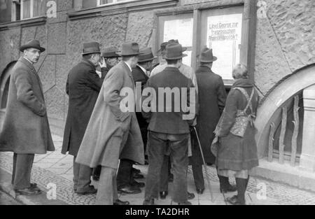 At the time of the occupation of the Ruhr, the German population was informed of news by means of billboards. Here civilians read the statements of former British Prime Minister Lloyd George. Stock Photo